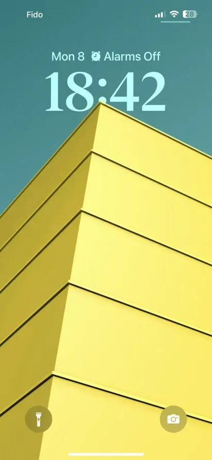 A low angle close-up photo of a yellow and black striped building's corner.
