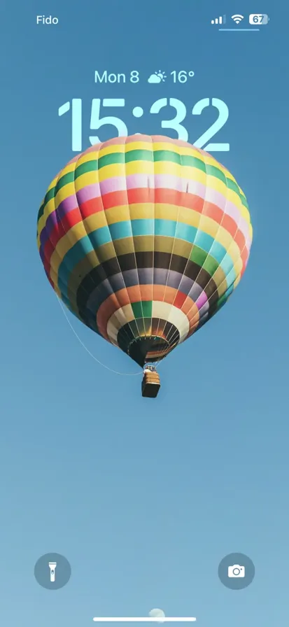 A multicolored hot air balloon floating peacefully under a clear blue sky - depth effect wallpaper