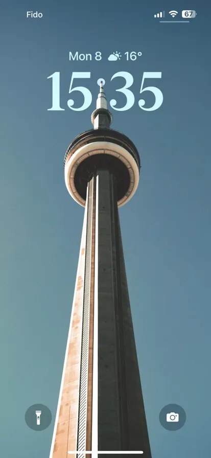 CN Tower towering above Toronto, showcasing its iconic design against a clear blue sky.
