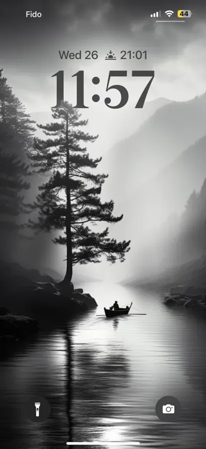 Tranquil River Scene: A Black and White Board Amidst Misty Trees and Fog