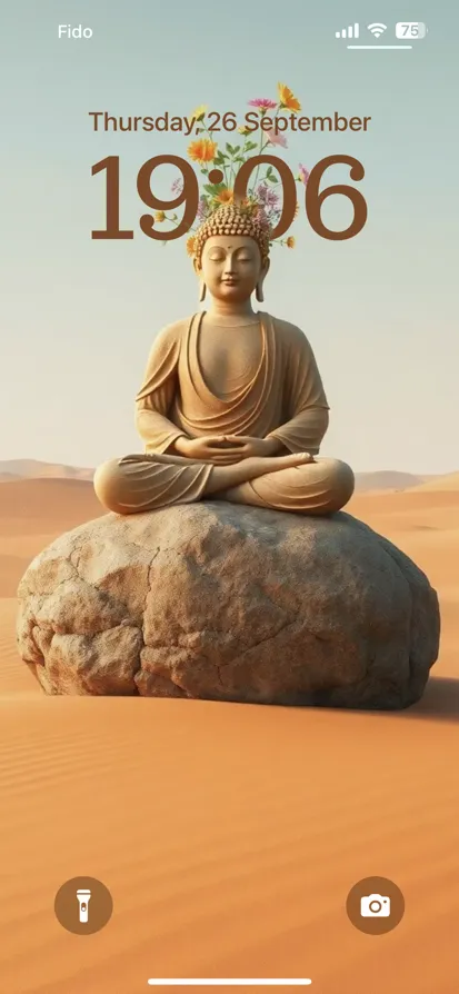 A seated Buddha statue on a rock in a peaceful desert.