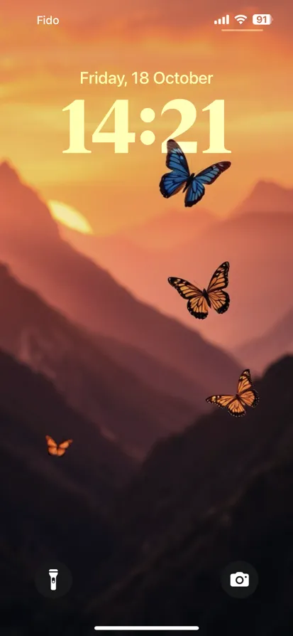 A vibrant sunset over mountains, with blue and orange butterflies in mid-flight.