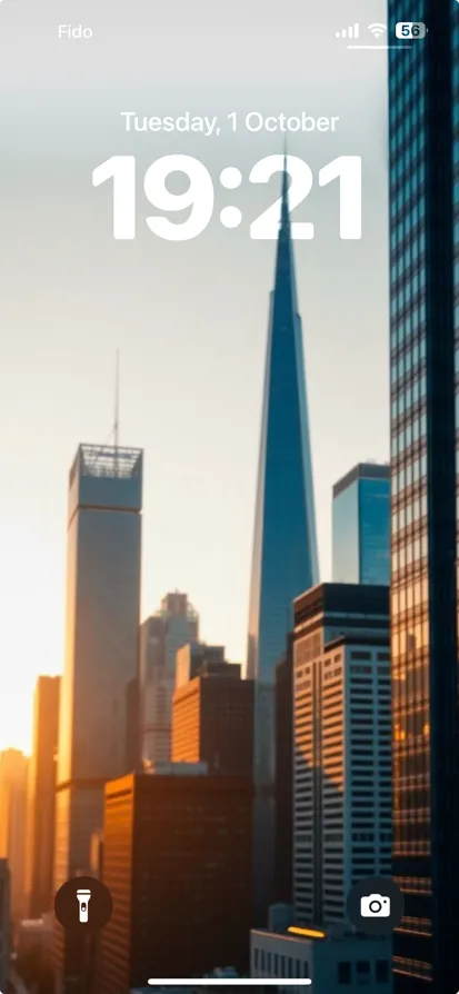 A vibrant city skyline at sunset featuring a tall skyscraper.