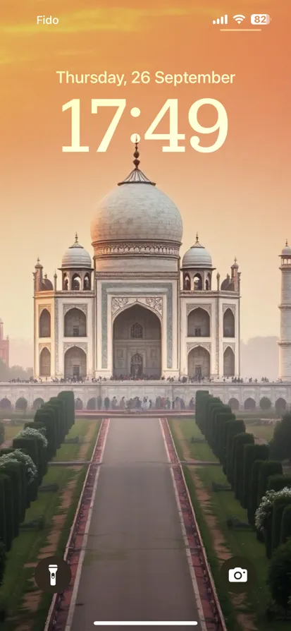 The Taj Mahal at sunrise, surrounded by lush gardens.