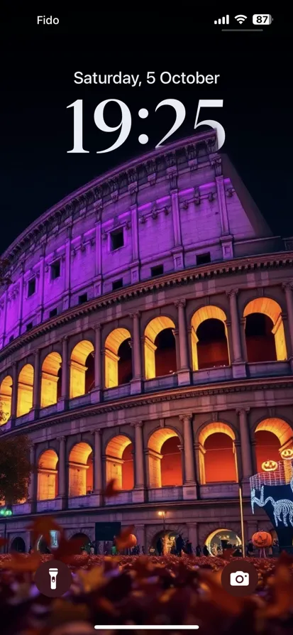 A night view of an illuminated amphitheater with autumn leaves and Halloween decor.