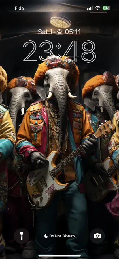 A rock band of elephants wearing colorful clothes performing on stage.
