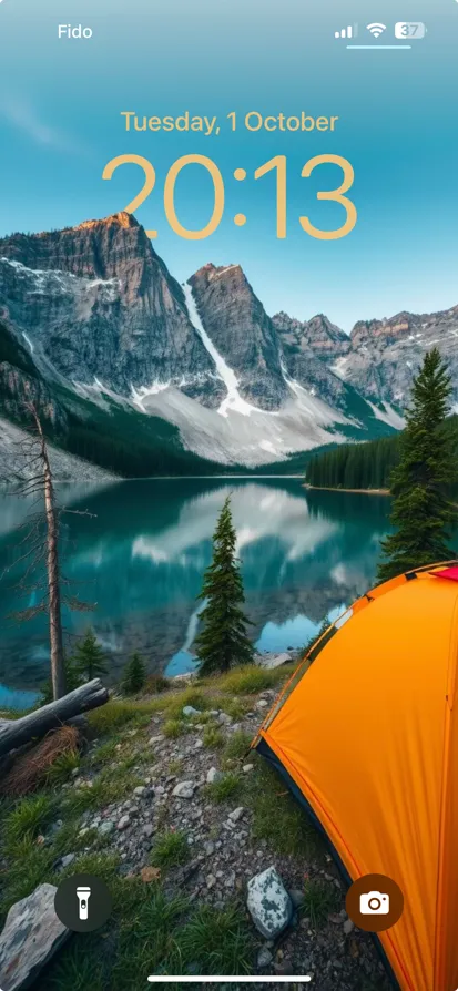 A vibrant orange tent near a calm blue lake and mountains.