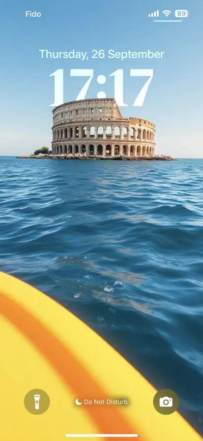 View of the Colosseum near calm blue waters on a sunny day.