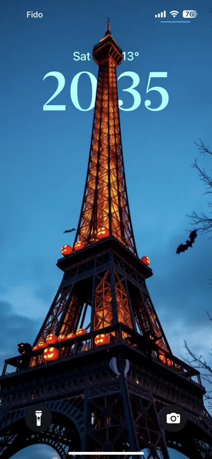 Eiffel Tower glowing with pumpkins and bats at twilight.