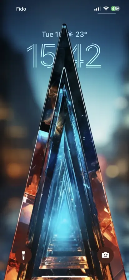 An abstract geometric triangle made of glass reflecting blue and orange light.