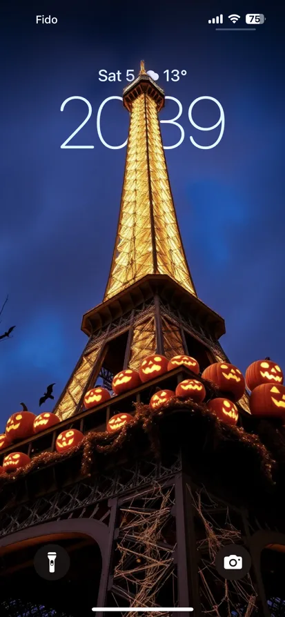 Eiffel Tower lit up for Halloween with pumpkins and bats.