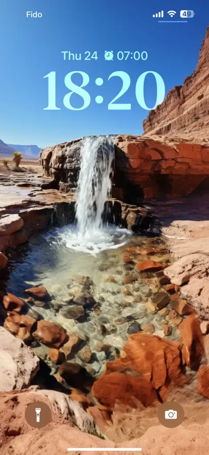 Breathtaking desert waterfall amidst vibrant colors, tranquil waters, rocky terrains & towering peaks.