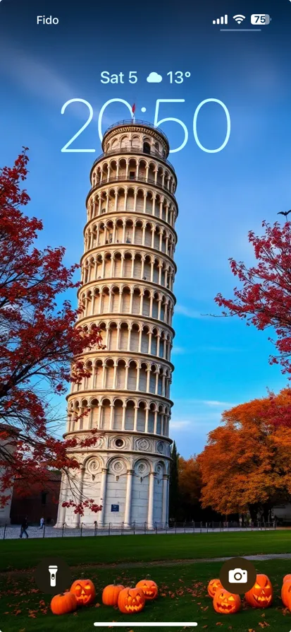 The Leaning Tower of Pisa with autumn foliage and carved pumpkins.