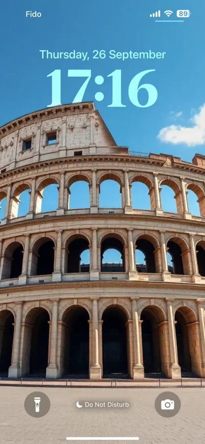 A low angle view of the Colosseum under a blue sky.