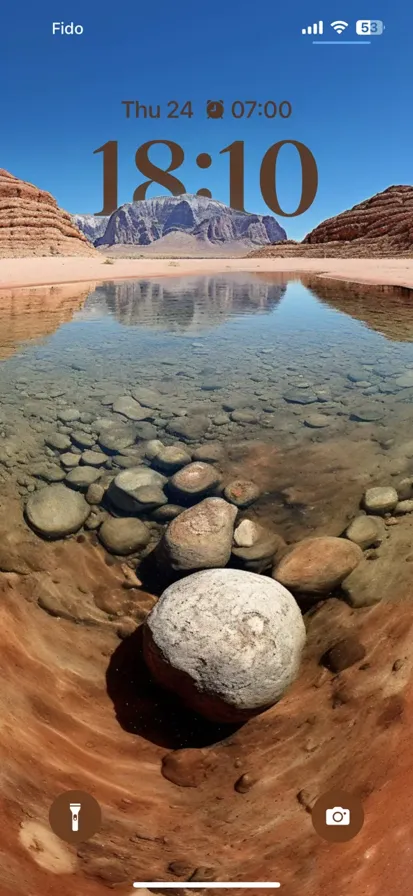 A beautiful landscape with desert mountains in the background and water in the foreground.