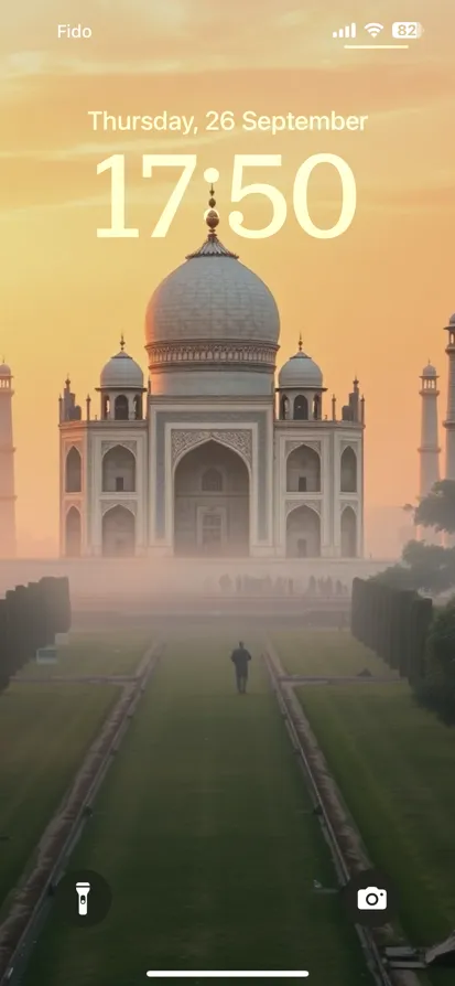 The Taj Mahal glows at sunrise, surrounded by mist and gardens.