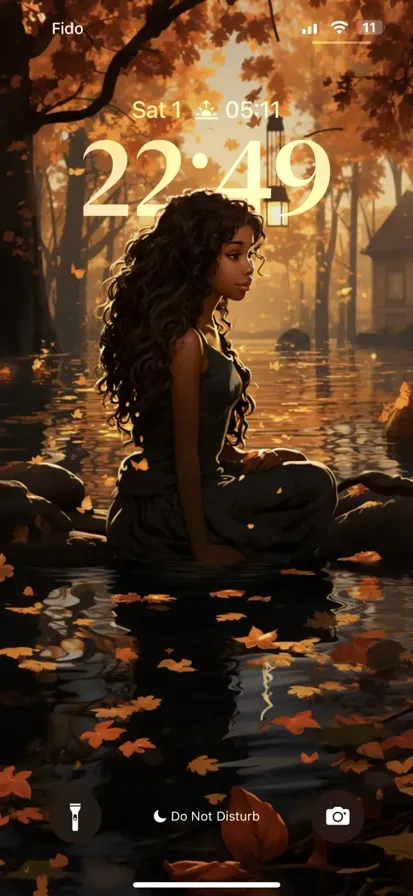 A confident black woman in a black dress poses elegantly, gazing into the horizon.